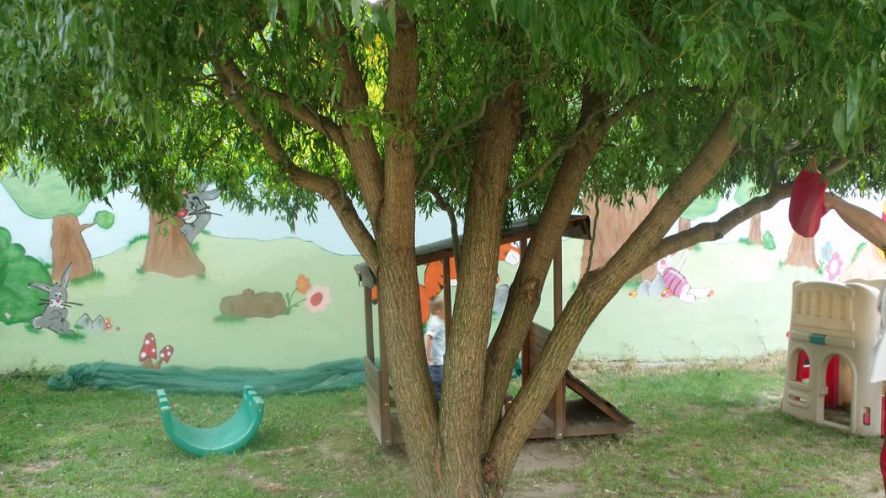 The picture shows the yard of the Nursery in Vác with playground toys.